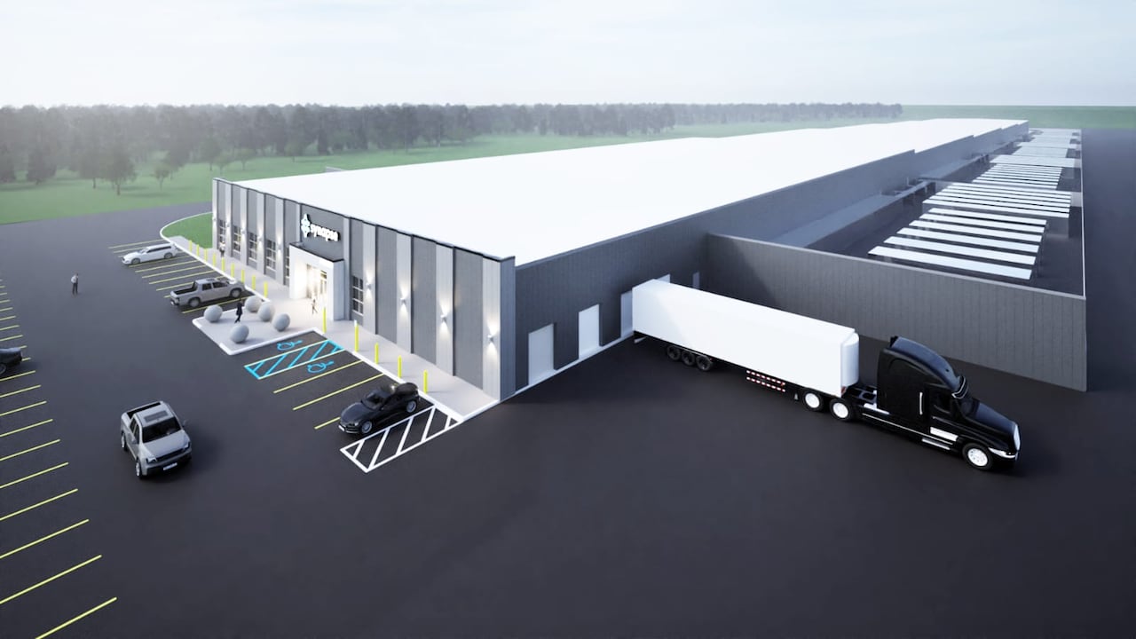 A computer rendering of a low, long building sitting in the middle of a parking lot.