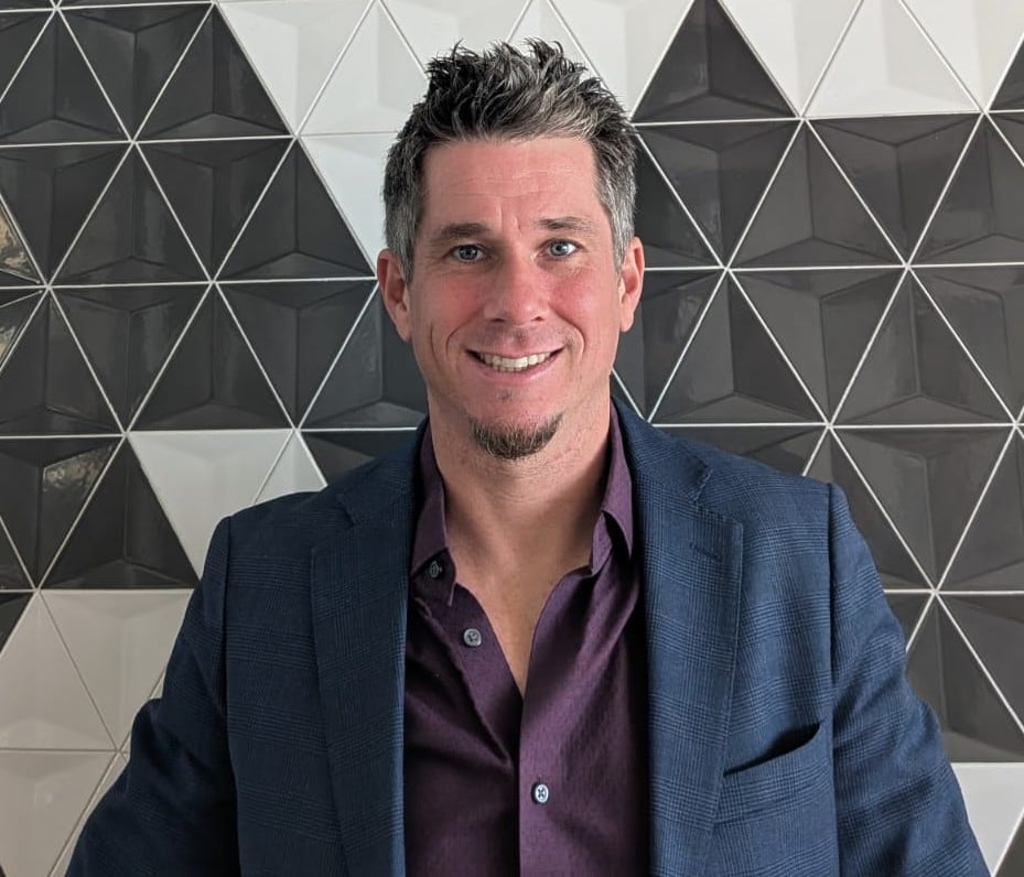 A man in a blazer and shirt.