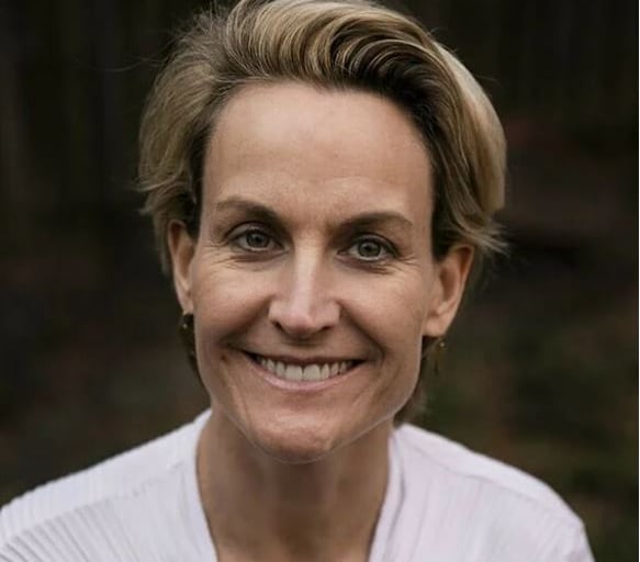 A woman is pictured in a closeup, headshot photo.
