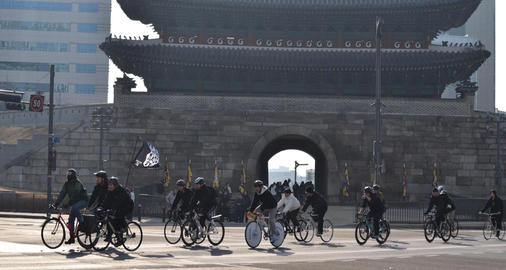 Cyclists ride past Namdaemun Gate during a Critical Mass ride in Seoul, Jan. 17. Courtesy of Bereket Alemayehu