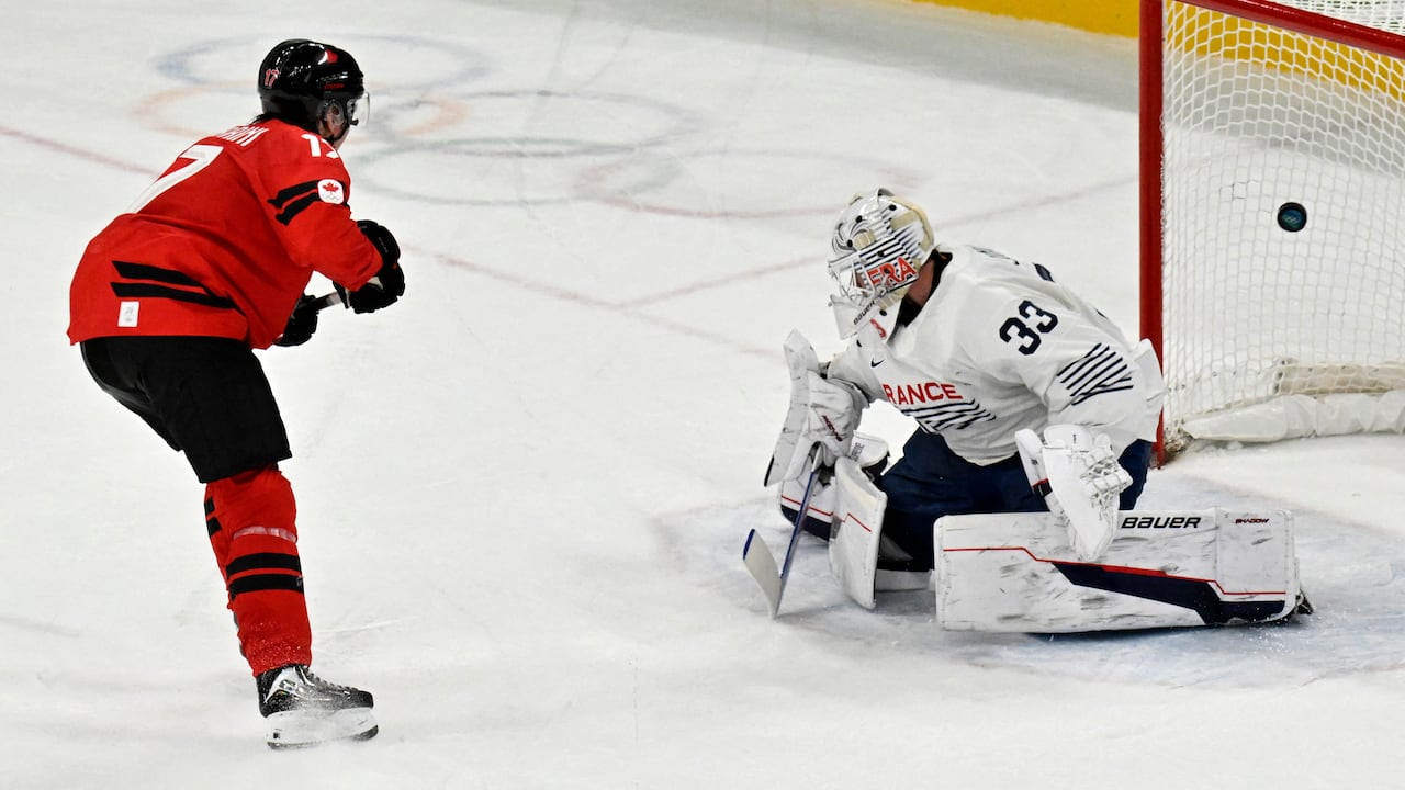 Two male Olympic hockey players.