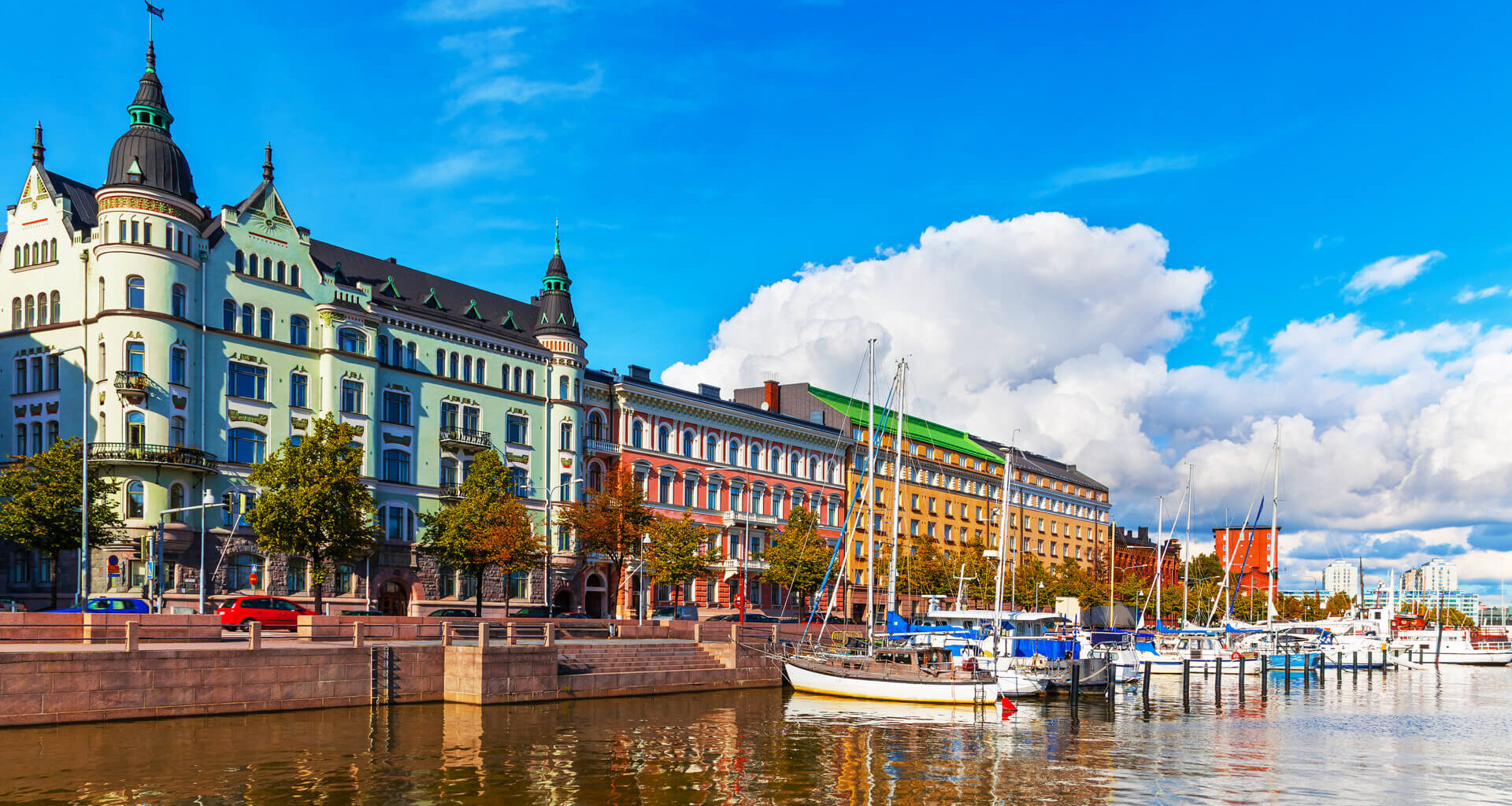 Scenic summer view of the Old Port pier architecture with ships, yachts and other boats in the Old Town of Helsinki, Finland.