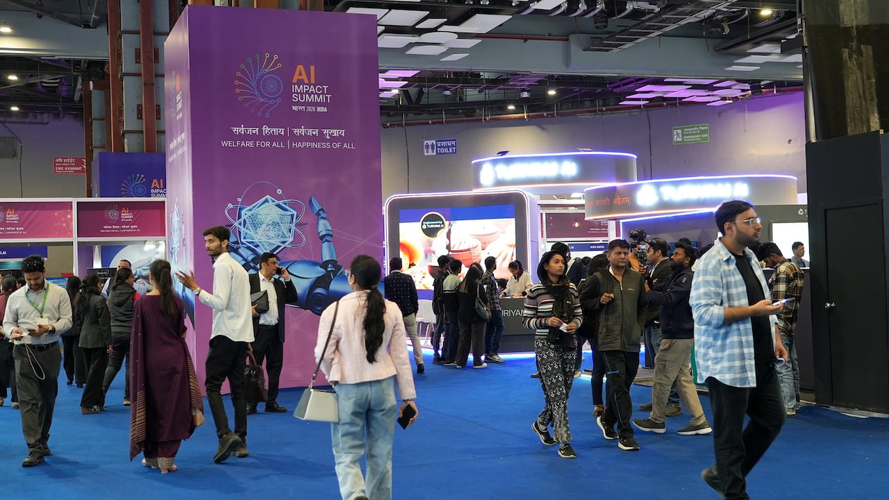 People walk through a convention centre.