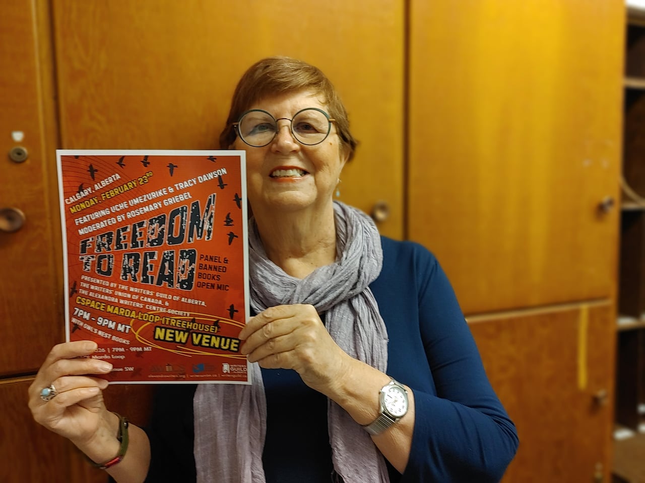 A woman holding a red poster