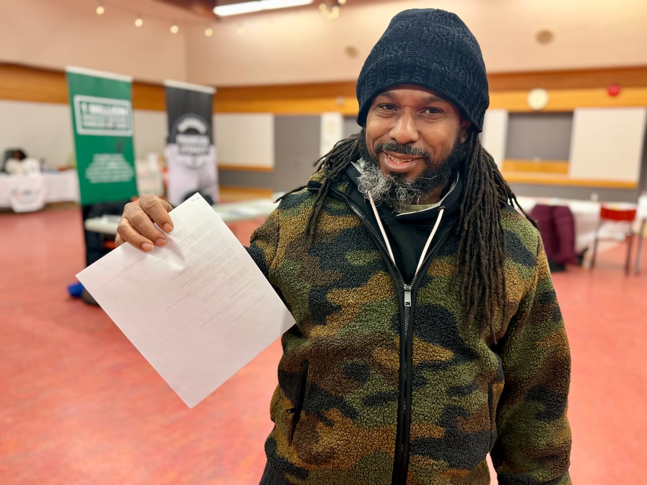 A man holding up a piece of paper