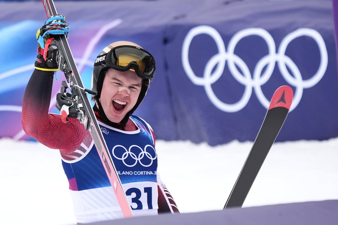 A skier celebrates crossing the finish line during training at the Winter Olympics.