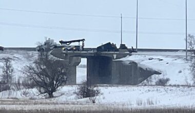 Truck dangles from snowy highway overpass in Winnipeg after crash
