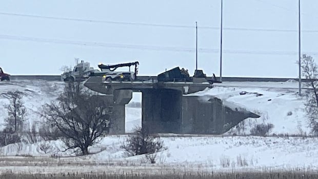 Truck dangles from snowy highway overpass in Winnipeg after crash