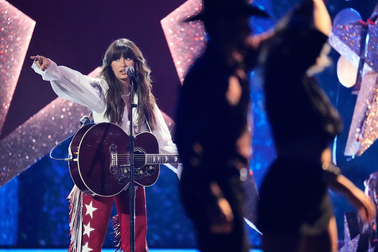 A musician points to the crowd during a concert.