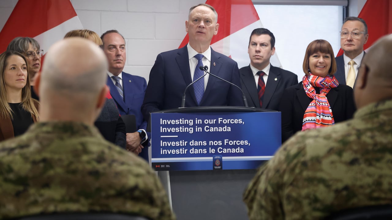 Man with a crowd in front of a podium