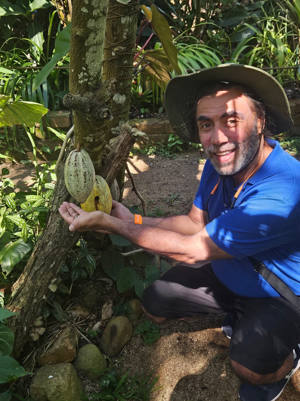 A man posing for a photo next to a tree in Mexico