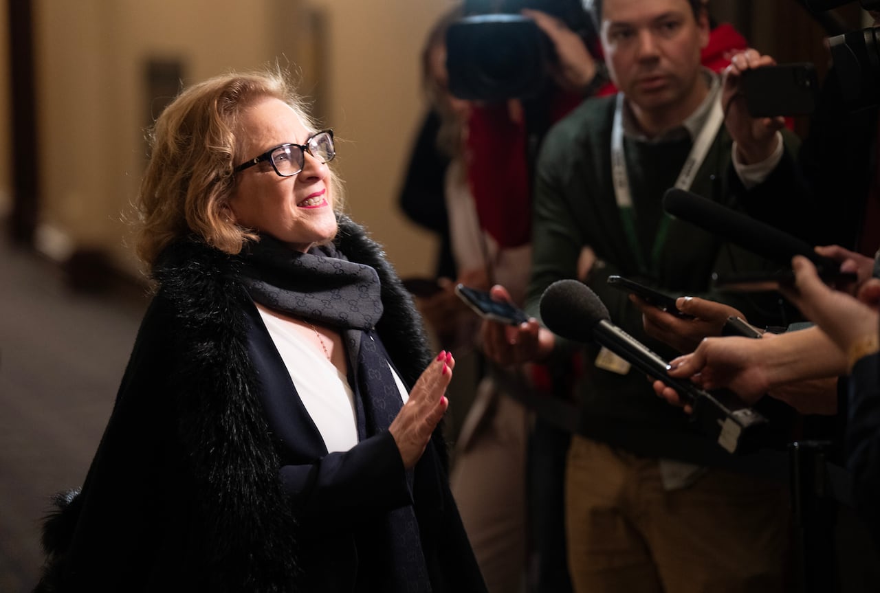 Diab speaks to reporters gathered around her in a scrum