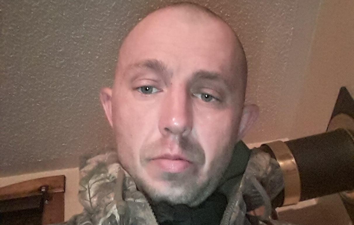 A man in a green camouflage jacket