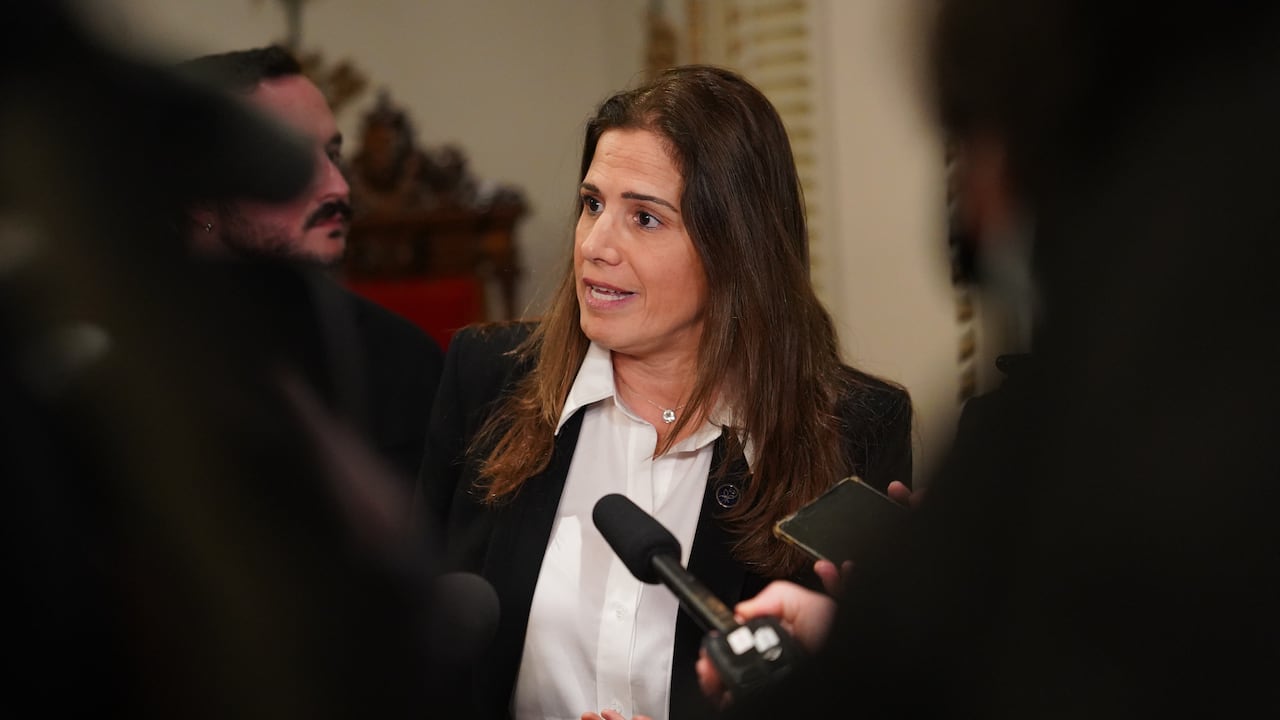 woman speaking to reporters