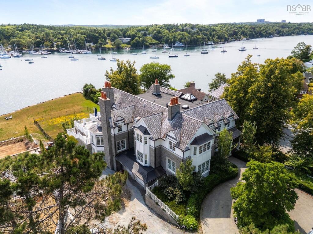 An aerial view of a large waterfront home.