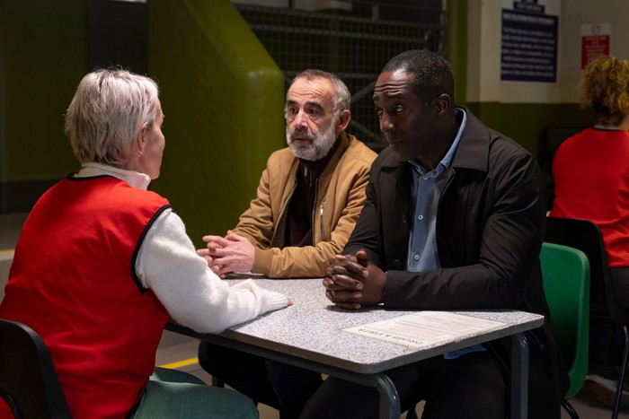 18_02_coro_debbie_kevin_ronnie_01 Kevin and Ronnie visit Debbie, who is wearing a red bib, in a prison visiting room in Coronation Street