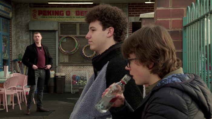 19_02_coro_will_sam_02 Sam, drinking from a bottle of vodka, sits with Will at the precinct in a scene from Coronation Street