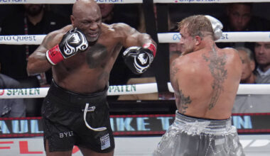 Mike Tyson, left, fights Jake Paul during their heavyweight boxing match, Friday, Nov. 15, 2024 ...