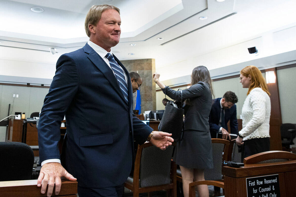 Former Raiders coach Jon Gruden leaves the courtroom after appearing at a hearing at the Region ...