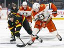 Vanccover Canucks centre Teddy Blueger checks Anaheim Ducks forward Ryan Strome during an April 5, 2025 meeting at Rogers Arena.