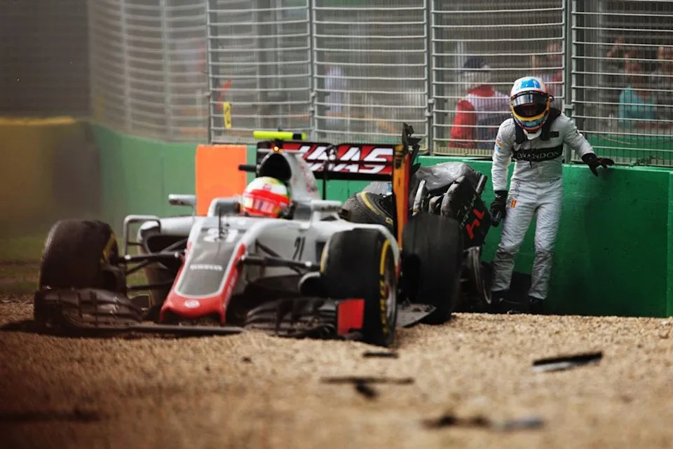 Fernando Alonso, McLaren, climbs out of his car after crashing Esteban Gutierrez, Haas F1 Team
