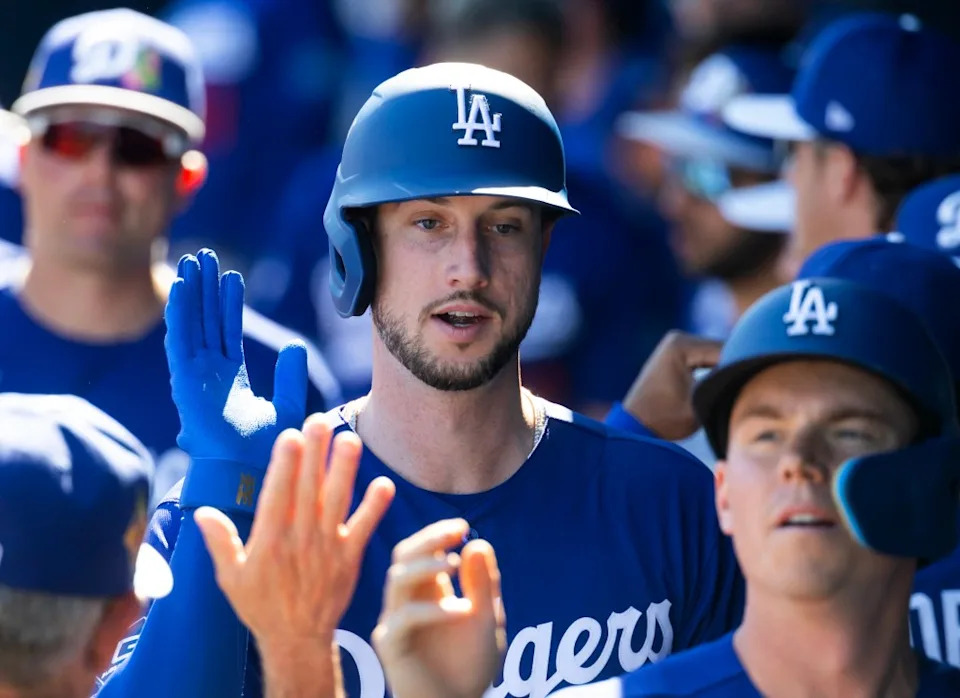 Kyle Tucker celebrates with teammates in the dugout after scoring against the San Diego Padres during a spring training game at Peoria Sports Complex. IMAGN IMAGES via Reuters Connect