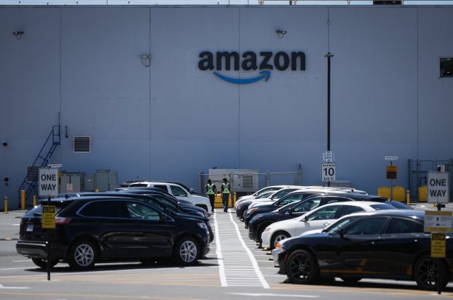 Security guards walk in the parking lot outside Amazon