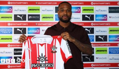Cyle Larin poses for a photo with the Southampton shirt after signing for the club