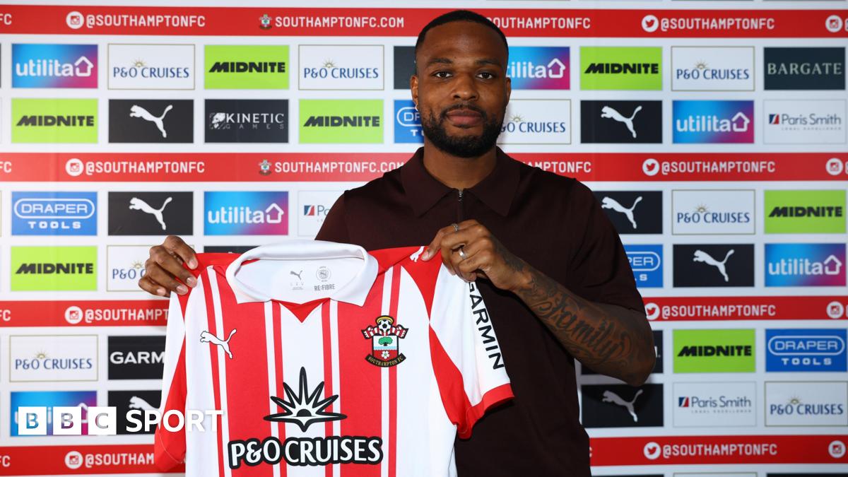 Cyle Larin poses for a photo with the Southampton shirt after signing for the club
