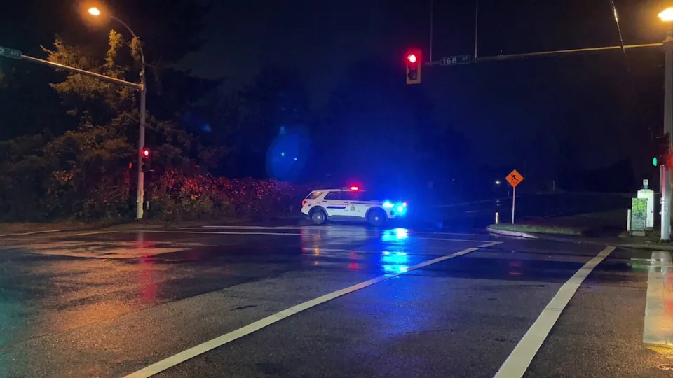 A police car blocked off an intersection at 168 St. and 32 Ave. after an extortion-related shooting on Nov. 12, 2025.