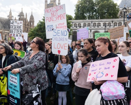 Campaigners take part in a rally outside the Houses of Parliament in London