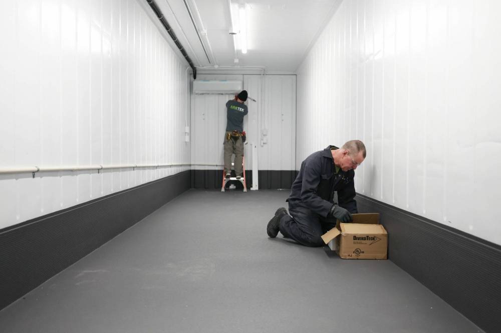 Ruth Bonneville / Free Press
NIBI Enviro Tech workers working on one of their units. The Winnipeg company designs and builds customized, modular mobile facilities out of shipping containers.