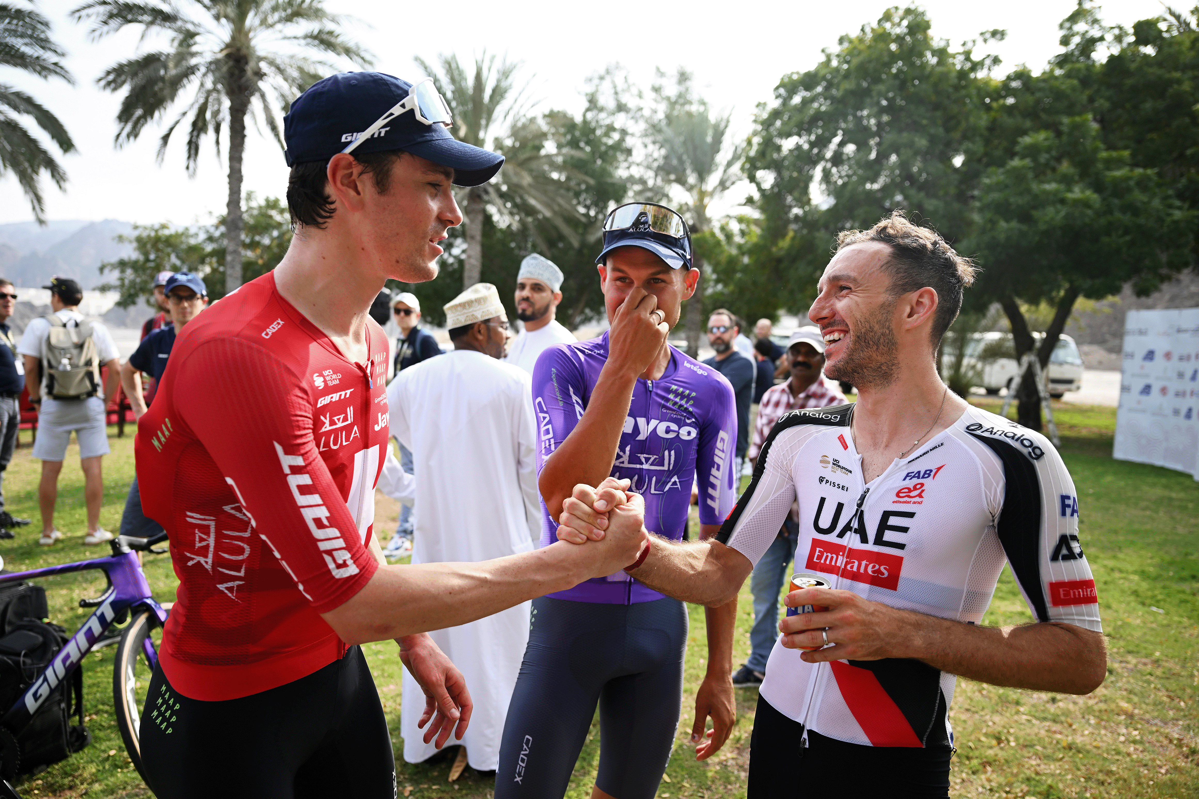 AL BUSTAN, OMAN - FEBRUARY 06: Stage winner Mauro Schmid of Switzerland, second place winner Luke Plapp of Australia and Team Jayco AlUla and the third place winner Adam Yates of Great Britain and UAE Team Emirates react after the 4th Muscat Classic 2026 a 176.2km stage from Al Mouj to Al Bustan on February 06, 2026 in Al Bustan, Oman. (Photo by Dario Belingheri/Getty Images)