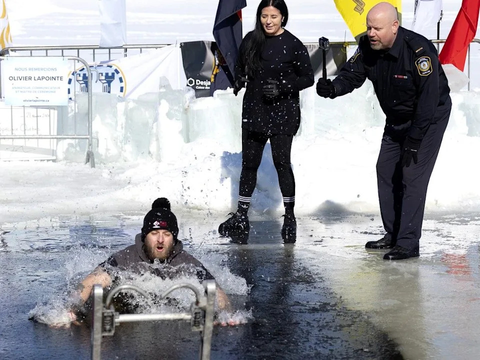 Quebec Security Minister Ian Lafrenière and Montreal Mayor Soraya Martinez Ferrada cheer on the first jumper into the St. Lawrence River for the Montreal police polar plunge in Montreal.