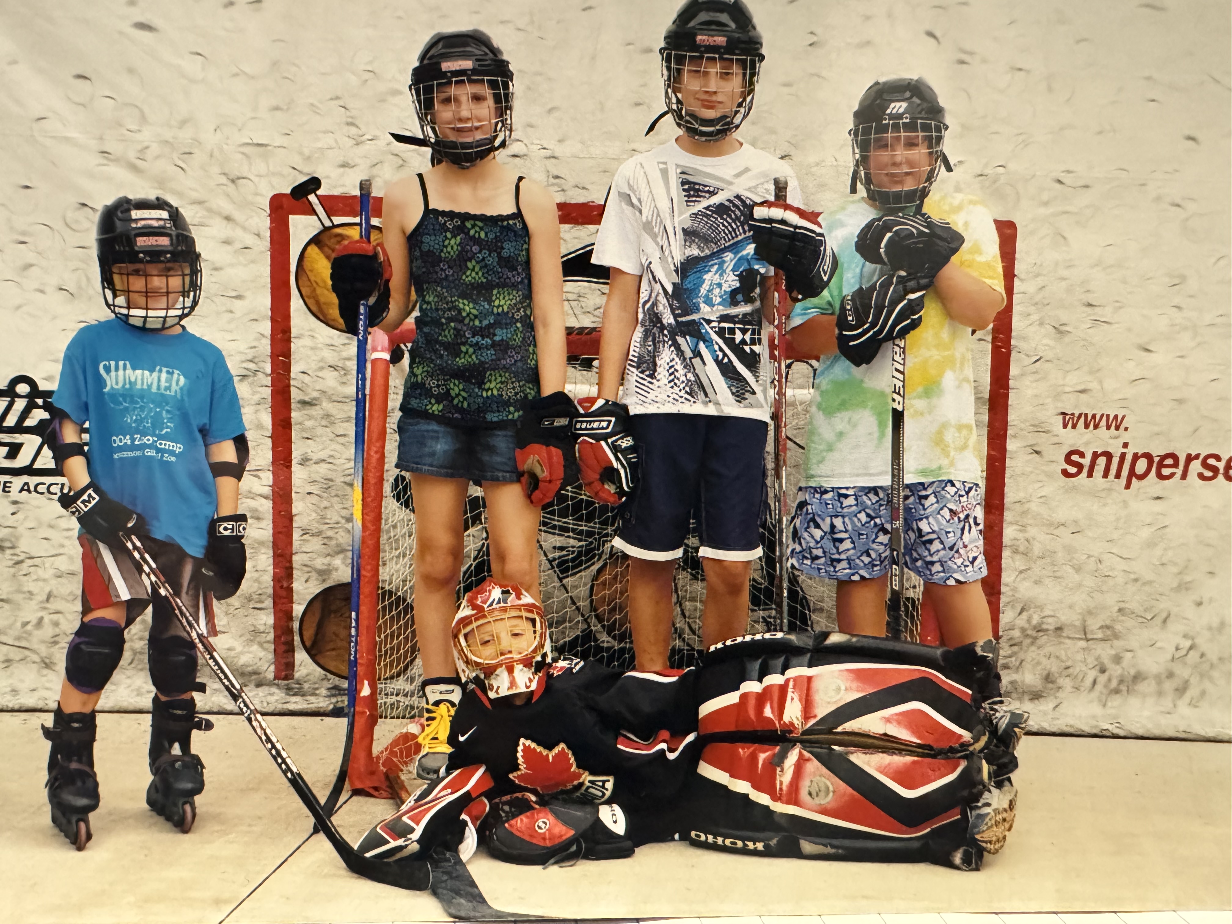 Thomas Harley, wearing Team Canada goalie pads, surrounded by, from left, younger brother Greg Harley, older sister Emilie Harley, older brother Stuart Harley and Gavin Gray.