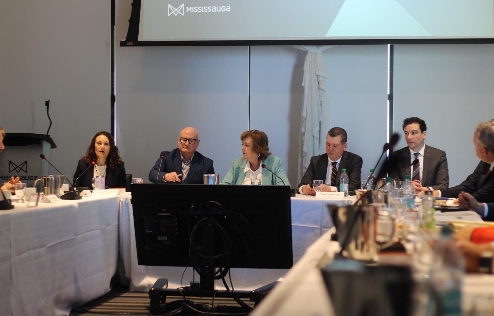 People sitting at a table talking having a formal conversation