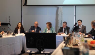 People sitting at a table talking having a formal conversation