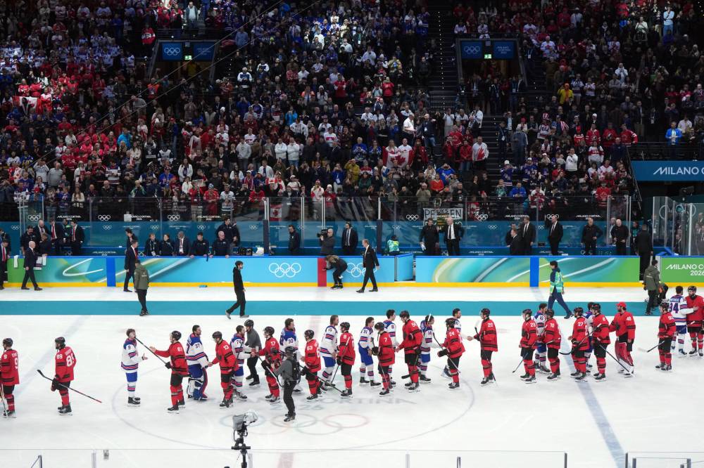 The United States and Canada shake hands after Canada lost in overtime during the men’s gold medal hockey game at the 2026 Winter Olympics, in Milan, on Sunday, Feb. 22, 2026. (Darryl Dyck / The Canadian Press)