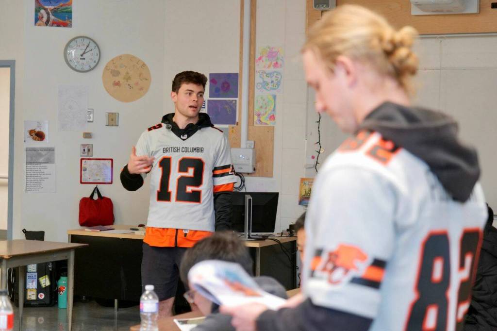 Nathan Rourke and Kieran Poissant speak to students at Lambrick Park Secondary School as part of the Be More Than a Bystander presentation. (Tony Trozzo/Saanich News)