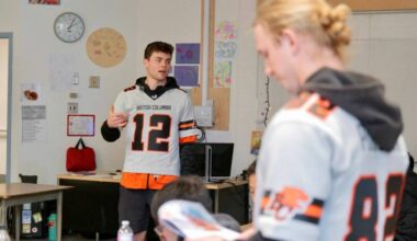 Nathan Rourke and Kieran Poissant speak to students at Lambrick Park Secondary School as part of the Be More Than a Bystander presentation. (Tony Trozzo/Saanich News)