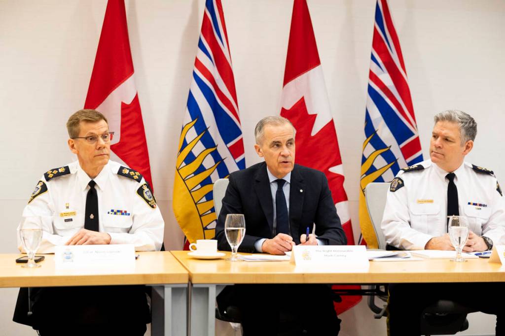 Surrey Police Chief Norm Lipinski, Prime Minister Mark Carney, and RCMP Deputy Commissioner Dwayne McDonald during the meeting with senior law enforcement leaders of the B.C. extortion task force at B.C. RCMP &ldquo;E&rdquo; Division headquarters in Surrey on Thursday, Feb. 19, 2026. (Anna Burns/ Surrey Now-Leader)