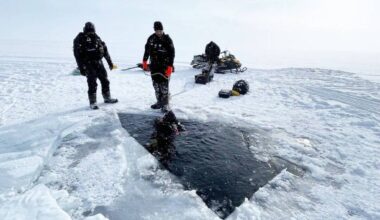 Members of the RCMP Underwater Recovery Team dive under Charlotte Lake to recover the bodies of a 100 Mile House couple who died in a snowmobile accident. (RCMP photo)