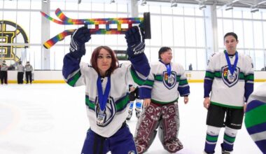 NHL Pride Cup trophy lifted by a hockey player at a rink in Boston, MA, in February 2025. (Photo: Brian Babineau via facebook.com/NHLUnites)