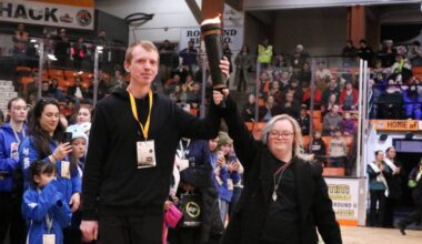 Trail bowler Tim Flack and swimmer Alyssa Berdusco make their way to light the 2026 BC Winter Games cauldron.(Jim Bailey/Trail Times)