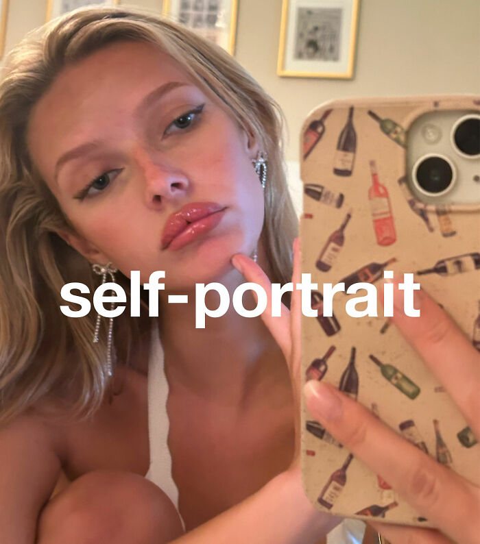 Apple Martin taking a self-portrait selfie, revealing cosmetic procedures, holding phone with wine bottle patterned case. Apple Martin taking a self-portrait selfie, revealing cosmetic procedures, holding phone with wine bottle patterned case.