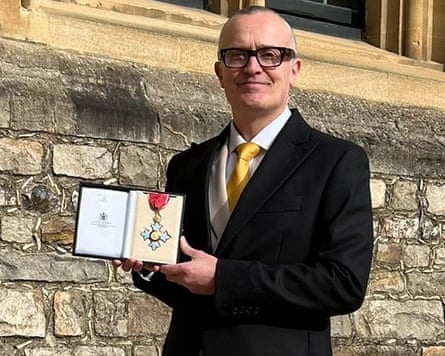 Ben Terrett holding up CBE