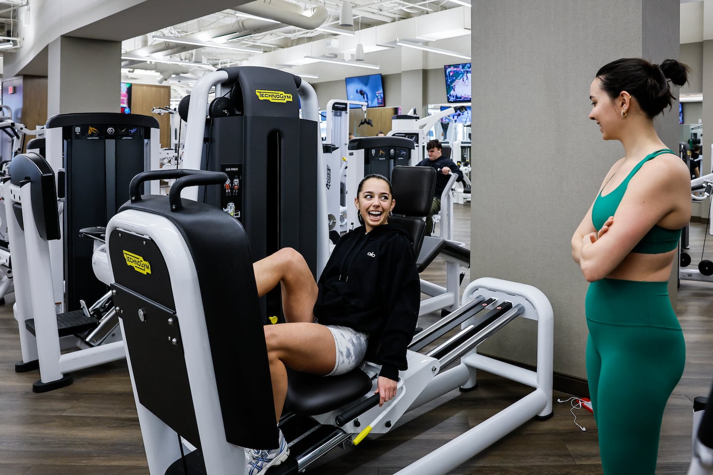 Carina Siolfi (left) used a leg press machine as Mia Dyman looked on at the Life Time fitness club, on Jan. 23.