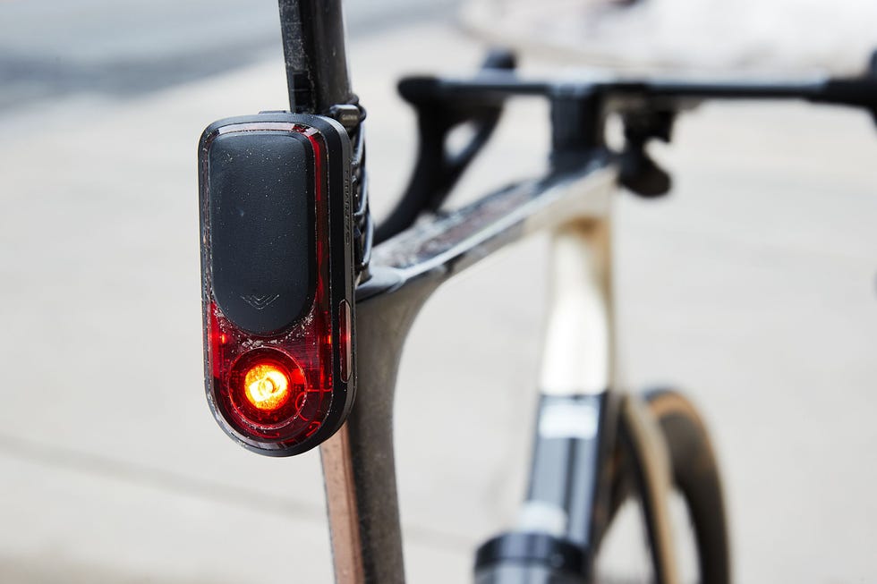 Bicycle rear light mounted on a bike frame, illuminated. Bicycle rear light mounted on a bike frame, illuminated.