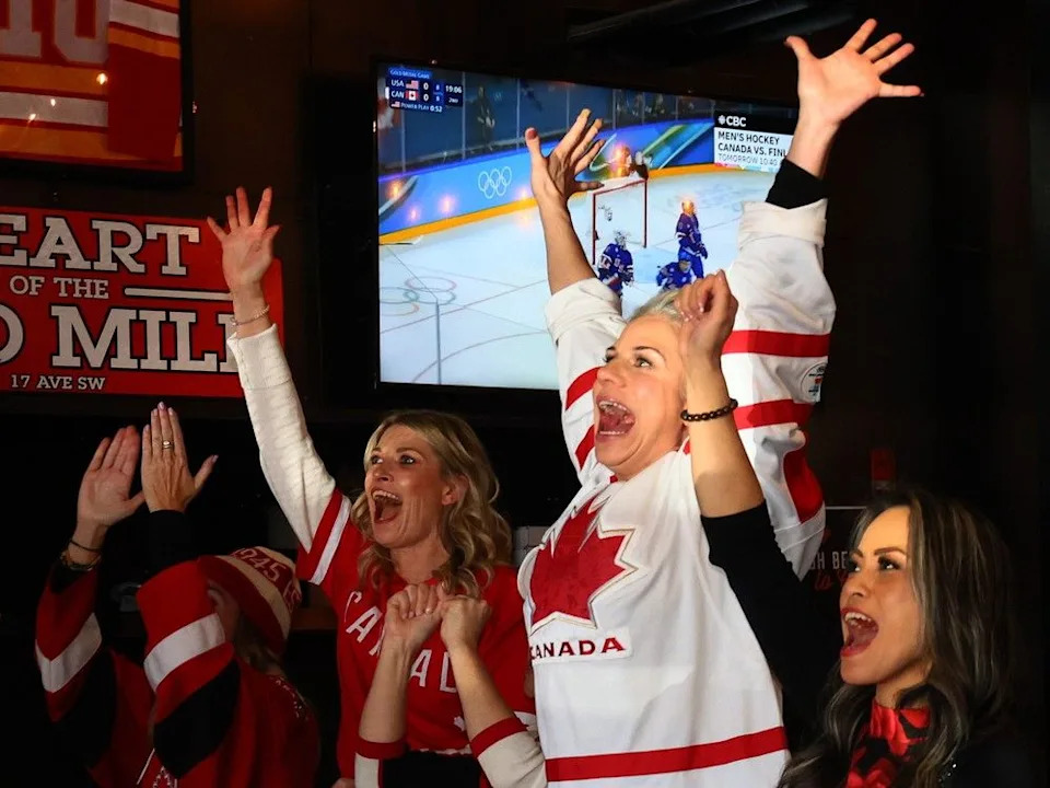 Hockey fans at Trolley 5 react to the women’s gold medal game against the USA in Calgary on Thursday, February 19, 2026.