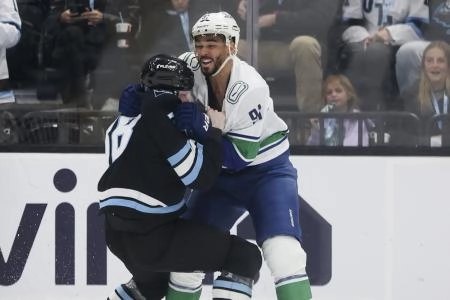 Feb 2, 2026; Salt Lake City, Utah, USA; Vancouver Canucks left wing Evander Kane (91) and Utah Mammoth center Liam O'Brien (38) fight during the third period at Delta Center.